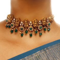 The Neema Lakshmi Floral Choker is an antique southern temple-inspired design featuring Lakshmi motifs surrounded by beautiful flowers in a choker pattern. Perfect for layering with our long haars. Luxury Women's Temple Jewelry Choker, Lakshmi Choker Necklace, Layered Haram Gold, Traditional Luxury Necklaces With Motifs, Kundan Choker Necklace Gold, Indian Emerald Jewellery, Emerald Necklace Indian Gold Jewellery, Temple Bangles Gold Jewellery, Neck Pieces Jewelry Indian