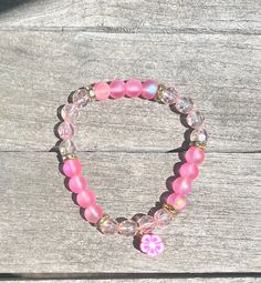 pastel pink flower bracelet Spring Rose Gold Flower Bracelets, Pink Crystal Bracelet Gift, Spring Rose Gold Flower Bracelet, Pink Round Crystal Bracelet Gift, Trendy Pink Flower Jewelry, Handmade Pink Crystal Round Bracelet, Pink Adjustable Crystal Bracelet With Round Beads, Trendy Pink Wristlet For Spring, Pink Casual Stretch Bracelet For Spring