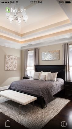 a bedroom with a large bed and two windows in the ceiling, along with a rug on the floor