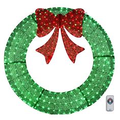 a christmas wreath with red and green lights on it's side, in the shape of a bow