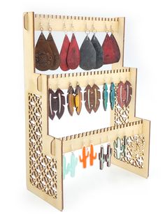 a wooden rack with several pairs of earrings hanging from it