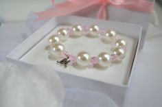 "Flower Girl Bracelets personalized with her monogram initial make a pretty gift for any little girl in your bridal party. Child size FAUX pearl bracelets have alternating Sparkly Pink Crystal beads between some of the faux pearl and a little dainty monogram charm. Add a beautiful gift box with or without a Beautiful Flower Girl Thank You Card Or Flower Girl Proposal Card for the perfect packaging. It is handmade with high-quality materials that will last. All of our bracelets can be made for in Personalized Pink Pearl Bracelet For Birthday, Pink Hypoallergenic Bracelets For Wedding, Pink Adjustable Bracelets For Bridesmaids, Cute White Jewelry For Bridesmaid Gift, Cute White Jewelry For Bridesmaids, Elegant White Name Bracelet For Birthday, Personalized Round Bracelets, Elegant White Bracelets, Elegant White Name Bracelet For Bridesmaid Gift