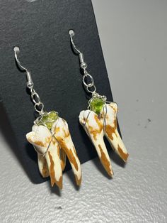 Real pig tooth earrings made with Serling silver and gold paint, the crystal attached at the top is calcite. Power lies within these earrings and gives the body state of relaxation and dissolves distractions. NO ANIMALS ARE HURT DURING PROCESS, bones come from deceased animals Bone Crafts Earrings, Animal Teeth Jewelry, Human Teeth Jewelry, Pig Teeth, Animal Teeth Japanese Jewelry, Shark Teeth Earrings, Animal Bones Jewelry, Fish Bone Earrings, Animal Bone Earrings