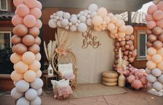 an outdoor baby shower is decorated with balloons and other items for the ceremony to be held