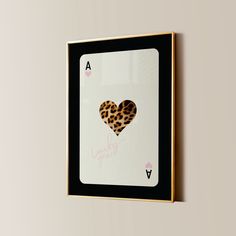 a card with a leopard print heart on the front and bottom, hanging on a wall