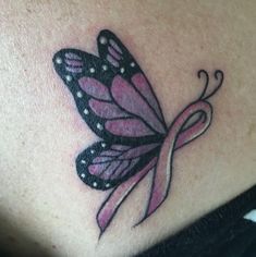 a woman's stomach with a pink ribbon and butterfly tattoo on the back of her belly