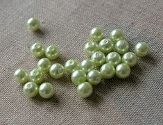 several green pearls are laying on the ground