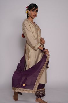 Ivory chanderi kurta with zardozi embroidered yoke. Comes with chanderi purple pant with embroidered hem and purple organza dupatta.
Component: 3
Pattern: Embroidered
Type Of Work: Zardozi Floral Motifs
Neckline: V-Neck
Sleeve Type: Three Quarter
Fabric: Kurta and Pant: Chanderi, Dupatta: Organza
Color: Ivory
Other Details: 
Lined kurta
Embroidered pant hem
Sequin and gota floral pattern on dupatta
Embroidered dupatta hem with fringed lace
Occasion: Puja - Aza Fashions Chanderi Dupatta, Embroidered Hem, Embroidered Pants, Purple Pants, Embroidered Dupatta, Organza Dupatta, Kurta With Pants, Pajama Set Women, Floral Motifs