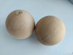 two wooden balls sitting next to each other on a table