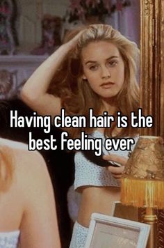 a woman looking at her reflection in the mirror with text saying having clean hair is the best