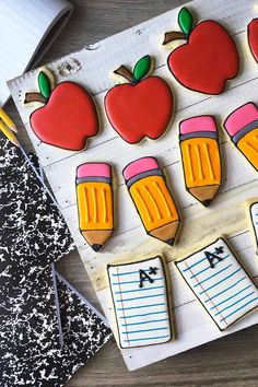 decorated cookies with erasers and pencils in the shape of apples