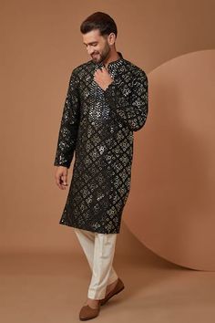 Black silk kurta with mirror embroidery.
Components: 1
Pattern: Embroidery
Type Of Work: Mirror
Neckline: Stand Collar
Sleeve Type: Full Sleeves
Fabric: Silk
Color: Black
Other Details: 
Note: Pant worn by the model is not for sale
Occasion: Sangeet - Aza Fashions Black Silk Kurta, Mirror Embroidery, Kurta Men, Silk Kurta, Pattern Embroidery, Kurta With Pants, Silk Embroidery, Mirror Work, Fabric Silk