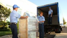 two men unloading boxes from the back of a truck