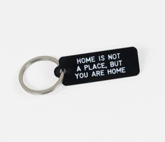 a keychain that says home is not a place, but you are home