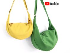 two purses are hanging on the wall, one is green and the other is yellow