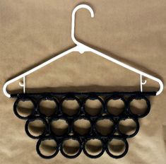 a coat hanger with several circles hanging from it's side on a brown background