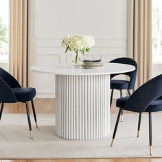 a white table with four chairs around it