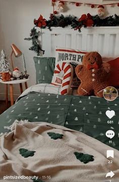 a teddy bear sitting on top of a bed in a room with christmas decorations around it