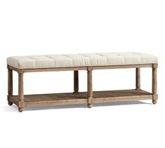 a bench made out of wood with a white upholstered cushion on the top