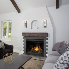 a living room filled with furniture and a fire place in the middle of the room