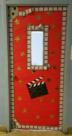 a red door decorated with stars and a movie clapper