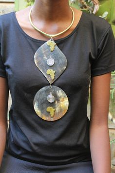 Handmade in Nairobi , Kenya! Crafted with horn pendants brass pendants and finished with a brass neckpiece. SHIPPING Shipping is done via DHL Express, 3-7 days delivery, Add multiple items to your cart and pay shipping for one item ONLY! Metal Necklace With Large Beads For Gift, Unique Necklace With Detachable Round Pendant, Handmade Brass Necklaces With Round Beads, Unique Metal Necklaces With Round Beads, Unique Brass Necklaces With Round Beads, Handmade Adjustable Pendant Drop Necklace, Unique Pendant Beaded Necklace, Unique Long Beaded Necklace, Handmade Metal Pendant Long Necklace