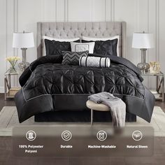 a bed with black and white comforters on it