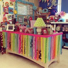 a colorful display in a store filled with lots of ribbons and pictures on the wall