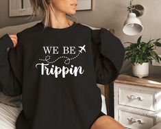 We Be Trippin Sweatshirt, Vacation Sweatshirt, Airplane Sweatshirt, Road Trip Sweater, Travel Hoodie, Travel Sweatshirt, Adventure Hoodie  Product Features 50% cotton/50% polyester Heather Sport 60P/40C Safety Green is ANSI/ISEA 107 compliant 20/1 Double-needle stitching at shoulder, armhole, neck, waistband and cuffs 1x1 rib with spandex Air jet yarn for softer feel and reduced pilling Tear away label How Do I Order 1- Please review all the information provided before placing an order 2- Select the shirt type and size using the drop down menu.  3- Select the color of the shirt using the following drop down menu. 4- Please add the vinyl color (white or black) in the optional message section of the order. 5- Need more Items? Add the current item in the cart. And If you like to add more item Vacation Relaxed Fit Hoodie Sweatshirt, We Be Trippin Vacation Shirts, Long Sleeve Graphic Print Sweatshirt For Adventure, Airplane Mode Sweatshirt, Beach Season Vacation Hooded Sweatshirt, Travel Hoodie, Vinyl Colors, Types Of Shirts, Road Trip