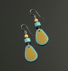 Textured turquoise and gold polymer clay teardrop beads (handmade by me with TLC!) have been accented with turquoise howlite cylinder beads, antiqued brass disc & round cedar wood beads in this lightweight tribal earring set.  The earrings are suspended from minimalist surgical steel ear wires.  A modern tribal earring pair that you will reach for again and again in the warm weather months when sand & sea colors make perfect wardrobe accents!  Dimensions: Dangle Assembly: 2.25  inches (5.7 cm) Total Earring Length: 2.75 in. (7.0 cm) Earrings are ready to ship and arrive tastefully packaged & gift-ready. Thanks for stopping in!  Return to shop: http://mindfulmatters.etsy.com Turquoise Teardrop Jewelry For Crafting, Unique Handmade Gold Teardrop Earrings, Gold Polymer Clay Jewelry For Crafting, Handmade Adjustable Turquoise Teardrop Earrings, Hand Painted Turquoise Drop Earrings, Gold Hand Painted Teardrop Earrings, Gold Teardrop Earrings Hand Painted, Handmade Yellow Teardrop Earrings, Turquoise Teardrop Hand Painted Earrings