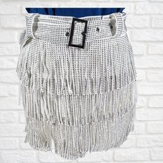 "No filter is needed, it sparkles just as bright as your soul does!  95% POLYESTER, 5% SPANDEX Color: White Fringe Skort Pewter Rhinestone Embellishments Matching Belt Back Zipper Closure Tiered Design Skirt Overlay With Shorts Lining Skort Has Some Stretch 16\" Waistband To End Of Fringe 2\" Inseam *Screen resolution, lighting may alter item color or design and brightness. Sizing- Small: 2-4 | Waist: 30 inches Hips: 35 inches Length: 14 inches Medium: 6-8 | Waist: 31 inches Hips: 39 inches Length: 14.25 inches Large: 10-12 | Waist: 32 inches Hips: 41 inches Length: 14.50 inches 1XL: 14-16 | Waist: 39 inches Hips: 46 inches Length: 16 inches 2XL: 18-20 | Waist: 41 inches Hips: 48 inches Length: 16.5 inches 3XL: 20-22 | Waist: 43 inches Hips: 50 inches Length: 17 inches ☆Returns & Exchanges Trendy White Party Skirt, Trendy White Party Mini Skirt, Trendy White Mini Skirt For Party, Chic White Skirt For Festival, White High-waisted Party Skort, White High Waist Party Skort, White High Waist Skort For Party, White Fringe Bottoms For Festival, Trendy White Skirt For Night Out