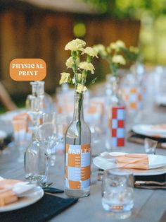 a table set with flowers and empty wine bottles