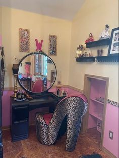 a leopard print high heeled shoe sits in front of a vanity with a mirror