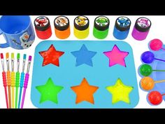 play doh stars and spoons are on the table with markers, pens and cups