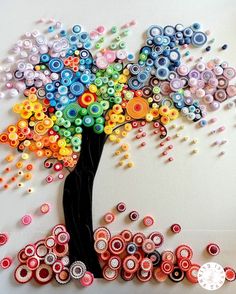 a colorful tree made out of buttons on a white background with the words button art written below it