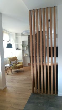 a room divider made out of wooden slats in the middle of a living room