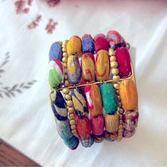 multicolored bracelets are stacked on top of each other with beaded details