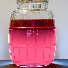 a jar filled with liquid sitting on top of a table