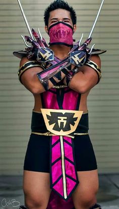 a man dressed in pink and black with two swords on his chest, wearing armor