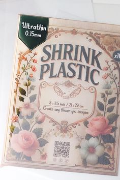 an advertisement for shrink plastic with flowers and leaves on the front, sitting on a white surface