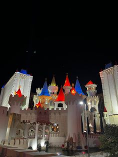 the las vegas hotel and casino is lit up at night with colorful lights on it