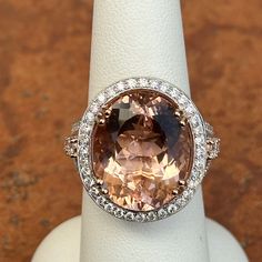 Vintage Oscar Friedman 14K white gold genuine, oval-cut, gem quality morganite with surrounding, round halo pave diamond ring Size 7 Can be resized for an additional fee up or down Genuine, oval, 12.70 carat Peach Morganite, checkerboard faceted 1.57 carat total weight natural diamonds; Mostly SI-I clarity; G /H/I color 150 diamonds Weight: 9.30 Grams Measures 24mm x 22mm top 13mm height Stamped 14KT Oscar Friedman and diamond comes with a certificate Oval Halo Ring For Formal Occasions, Formal Morganite Ring With Halo Setting, Formal Oval Topaz Ring With Halo Setting, Oval Morganite Jewelry For Formal Occasions, Elegant Oval Topaz Ring With Diamond Accents, Formal Morganite Rings With Halo Design, Formal Oval Topaz Ring With Halo Design, Oval Topaz Ring With Center Stone For Formal Occasions, Morganite Rings With Halo Design For Formal Occasions