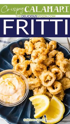 calamari fritter on a plate with dipping sauce and lemon wedges