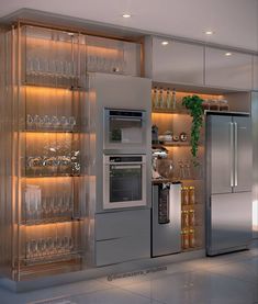 a modern kitchen with stainless steel appliances and wine glasses on the shelves, along with glassware