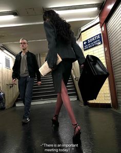 a man and woman walking down an escalator