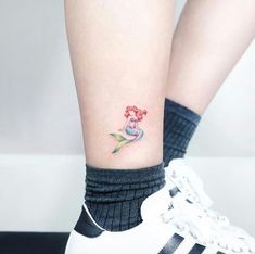 the little mermaid tattoo on the ankle is very cute and it looks like she's getting