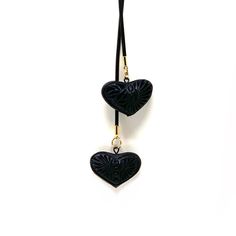 Indulge in the allure of Mexican craftsmanship with this exquisite handmade jewelry piece. Our Double Heart Necklace features two beautifully carved barro negro (black clay) charms, showcasing the rich artistry of Oaxaca pottery. Each piece is meticulously crafted by skilled artisans, ensuring a stunning, one-of-a-kind accessory. Capture the essence of Oaxaca's ceramic pottery tradition with this artisan heart necklace. The unique combination of barro mexicano and traditional Oaxacan design crea Oaxaca Pottery, Wool Knit Scarf, Handcrafted Boots, Painted Hats, Double Heart Necklace, Mexican Jewelry, Black Clay, Textile Jewelry, Double Heart