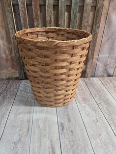 a brown basket sitting on top of a wooden floor