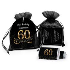 two black and gold birthday bags with the number 60 printed on them, one bag is filled with chocolates