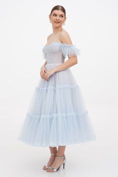 Buy Light Blue Ruffled Tulle Midi Dress at Milla Dresses. Wide size range from XXS to XXL. FREE shipping across the USA. Return in 30 days. Tulle Ball Gown Corset Dress With Ruffles, Elegant Blue Tulle Corset Dress, Tulle Corset Dress With Ruffles In Ball Gown Shape, Blue Tulle Dress With Boned Bodice, Cocktail Evening Dress With Lined Bodice And Tulle, Cocktail Corset Dress With Sheer Bodice And Tulle, Cocktail Dress With Corset Back And Tulle Material, Cocktail Evening Dress With Lined Bodice In Tulle, Evening Ball Gown Corset Dress With Ruffles